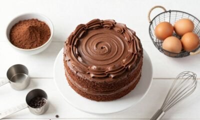 Beating chocolate buttercream frosting with electric mixer until light and fluffy"